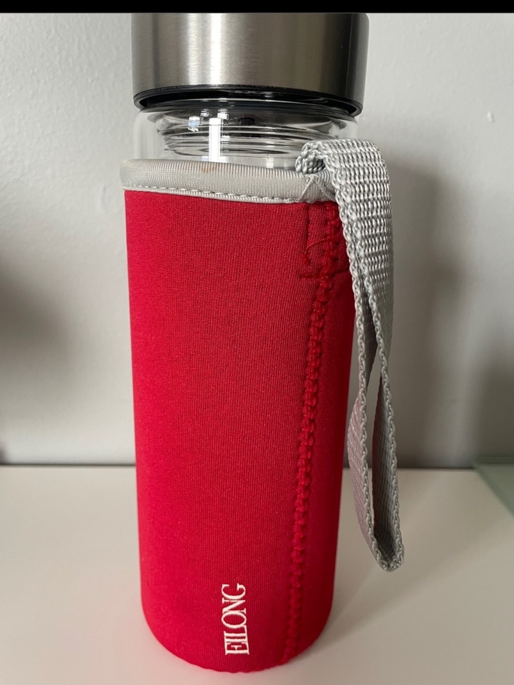 NWOT double layer Clear Glass Bottle with Silver Lid with red sleeves & strap